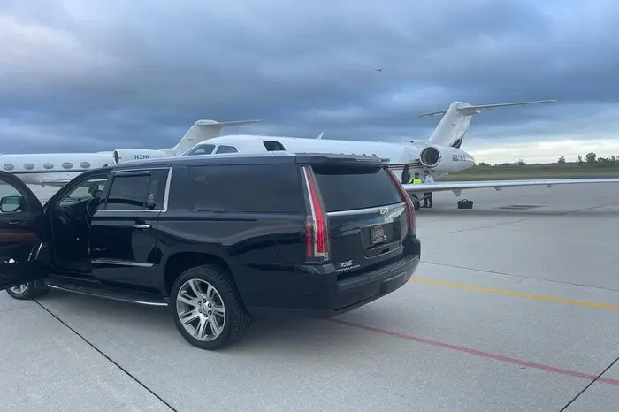 Royal Limousine Cadillac Escalade waiting planeside with the door open