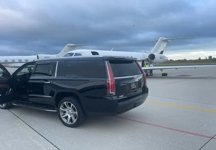Royal Limousine Cadillac Escalade waiting planeside with the door open