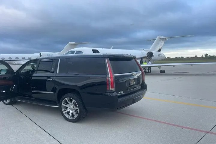 Royal Limousine Cadillac Escalade waiting planeside with the door open