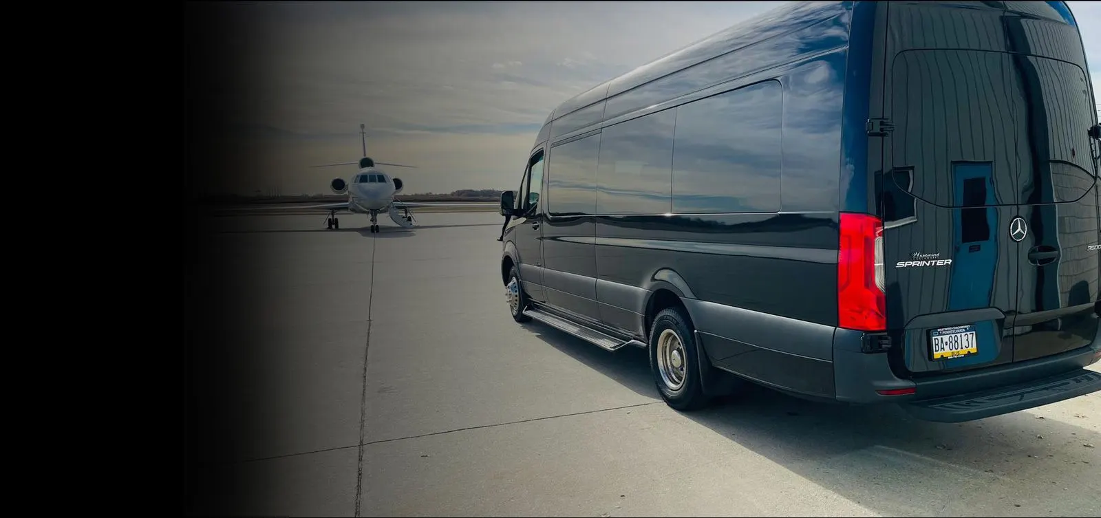 The Royal Limousine Mercedes-Benz Sprinter waiting beside a private jet on the tarmac